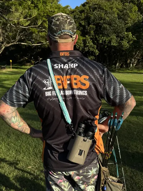 The back of a Big Fella's Bow Strings shirt on an archer at a shoot.
