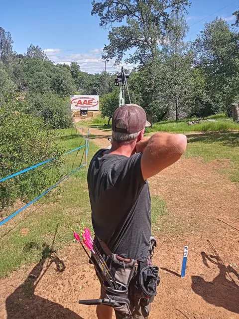 An archer on a field range, between the targets.