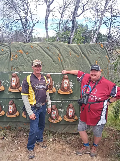 A group on a 3D course, targets set out among the trees.