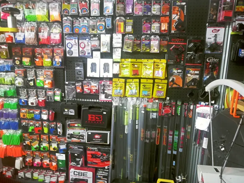 An archery shop wall stocked with strings, releases and accessories.