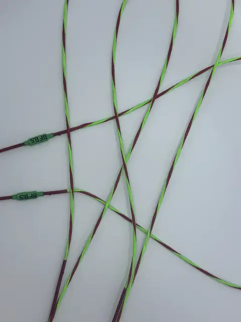 A finished set in Flo Green/Red with Red serving, coiled on white.