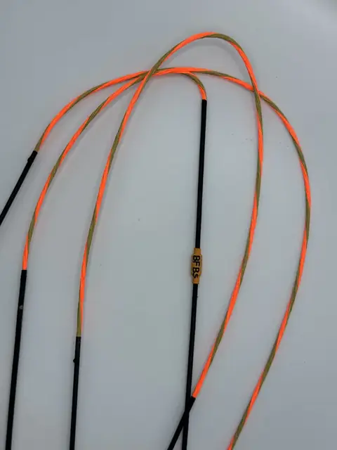 A finished set in Flo Orange/Buckskin with Black serving, coiled on white.