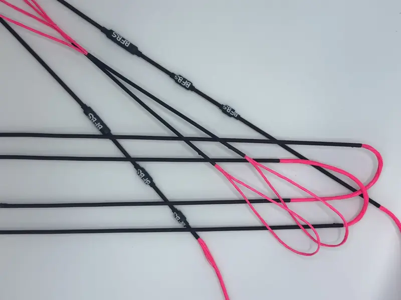 A finished set in Pink with Black serving, coiled on white.