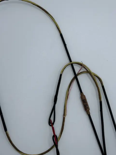 A finished set in Tan/Buckskin with Black serving, coiled on white.