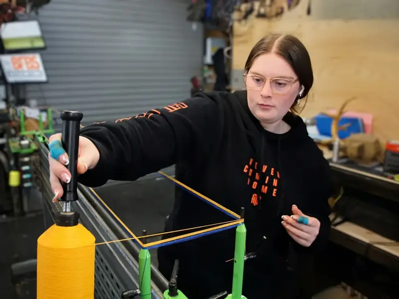 Laying up a string on the jig from a fluro yellow spool.
