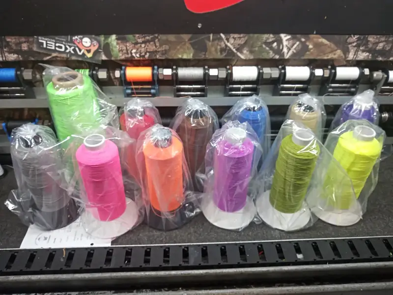 Pink, orange, purple and green string material on the rack.