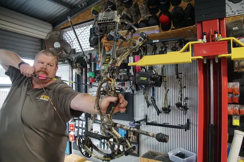 Tim drawing a customer bow in front of the press.